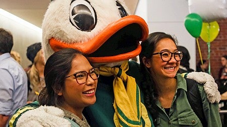 Two female students smiling with the Duck